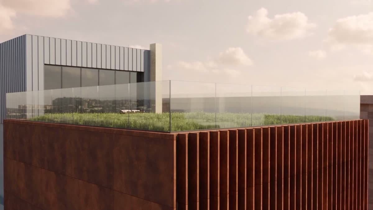 The planted roof terrace behind glass balustrades, with the plant room behind it.